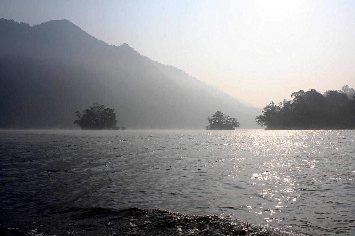 Morning mist on Ba Be Lake, with wooded islands and forested slopes
