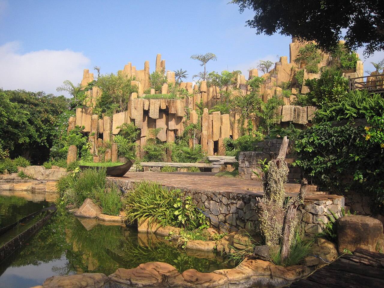 A stacked rock garden above a pond at Trung Nguyen Coffee Village