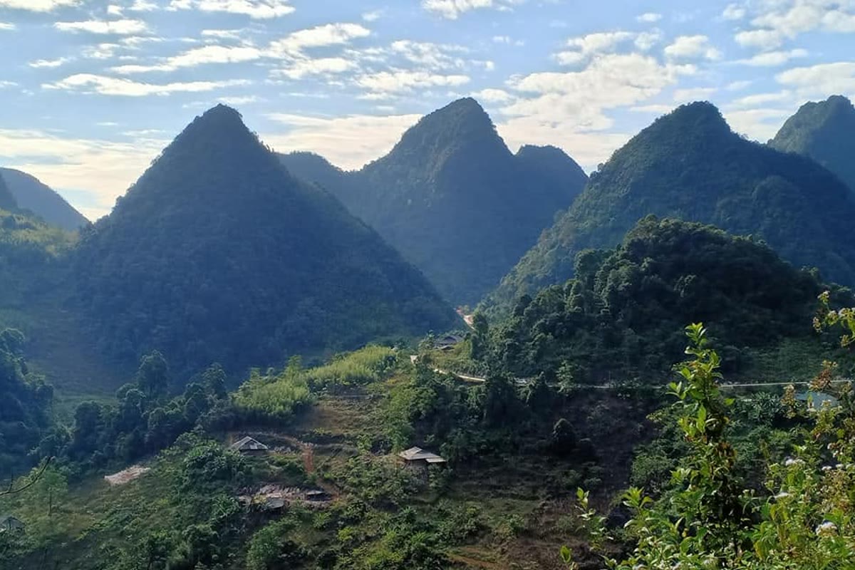 Forested karst peaks above a valley road in the Phia Oac–Phia Den reserve