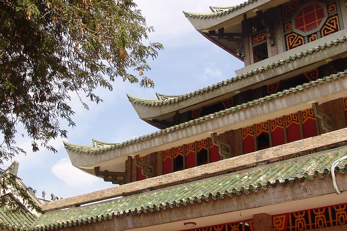 Close view of the curved green roof and red panels at Ba Chua Xu Temple