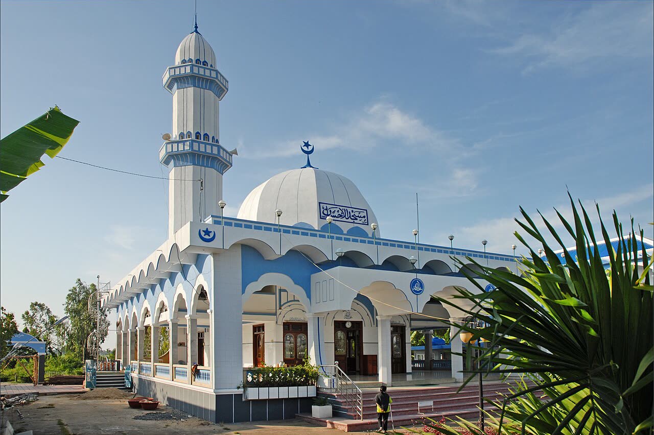 A white and blue mosque with a minaret in Đa Phước, opposite Chau Doc