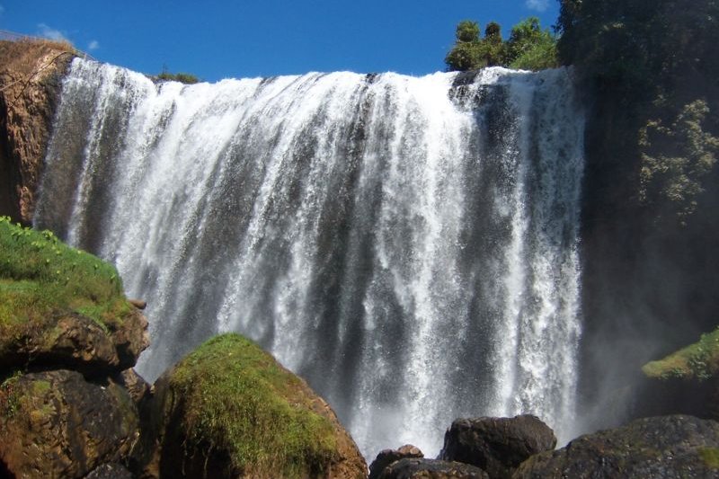 Elephant Falls seen from below, white water over a dark cliff