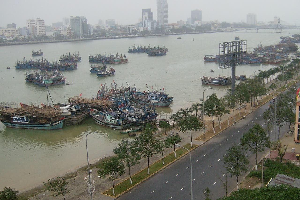 Fishing boats on the Han River with the far bank and a bridge in the haze