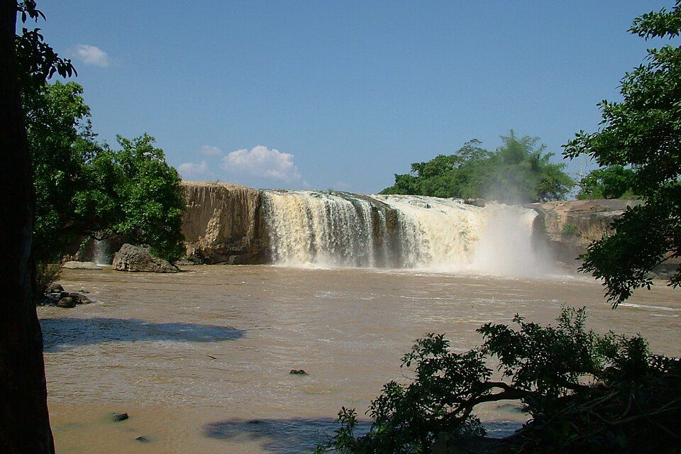 Dray Sap waterfall across the Serepok, seen through trees on both sides