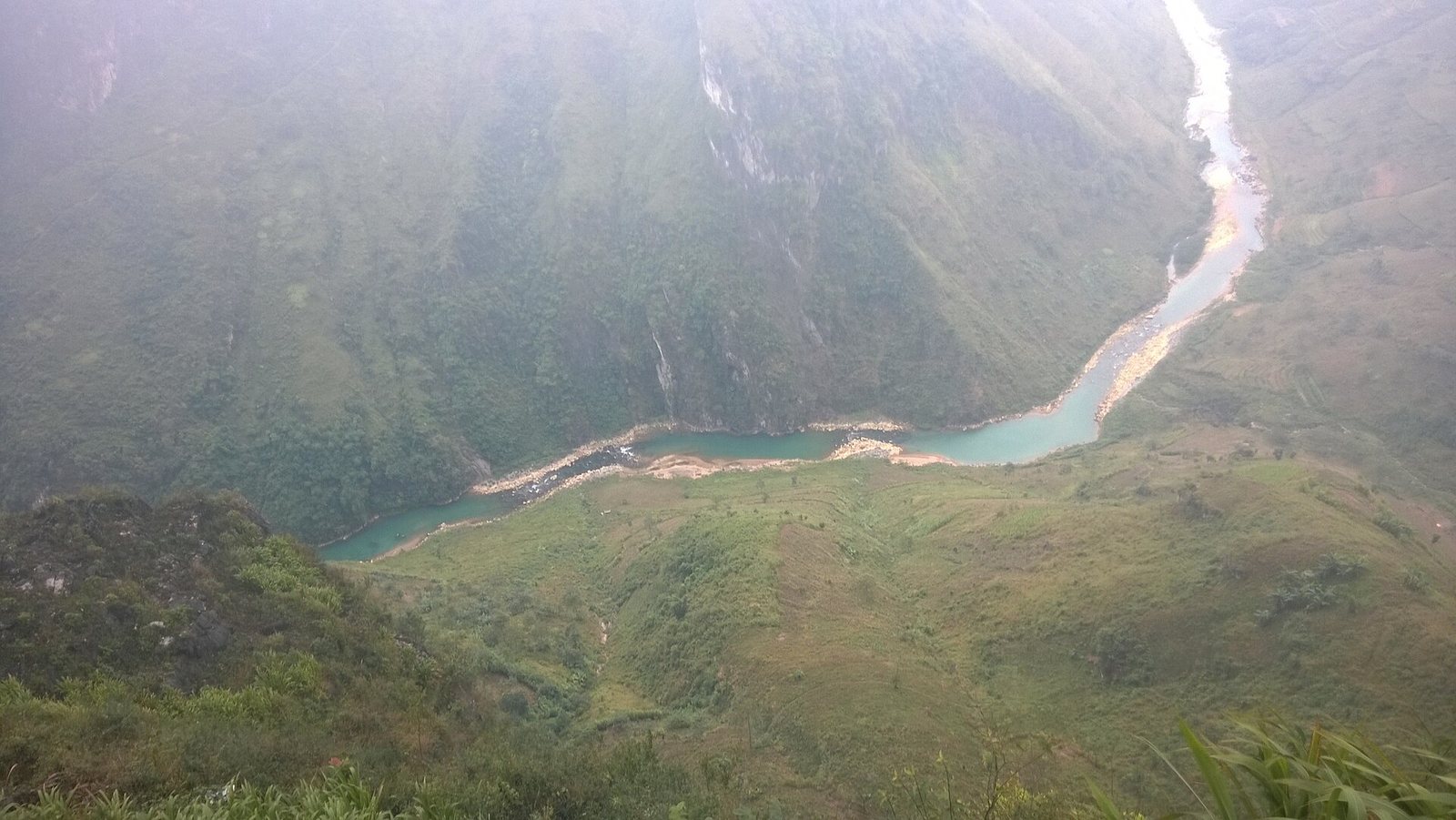Turquoise Nho Quế winding through green canyon walls below Ma Pi Leng