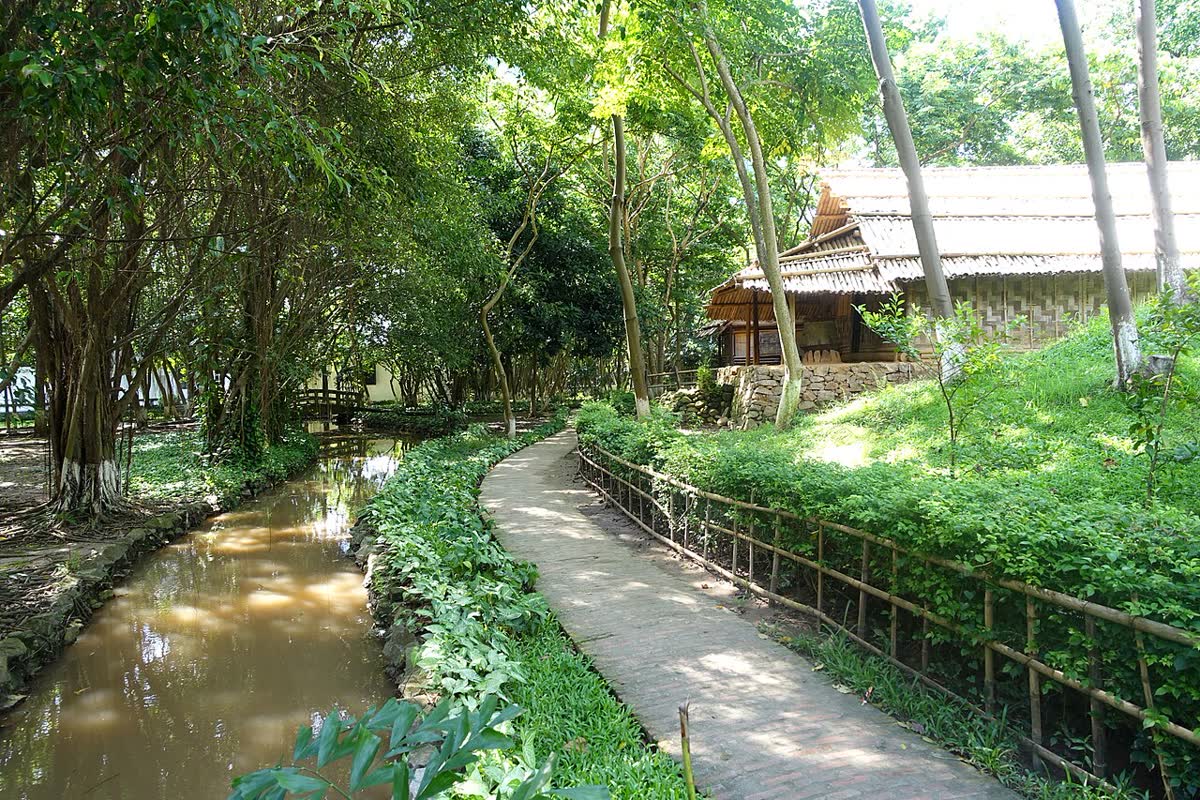 A path beside a thatched house at the Museum of Ethnology