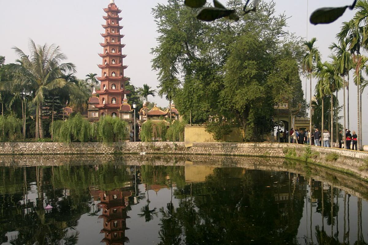 The stupa of Tran Quoc Pagoda above the water