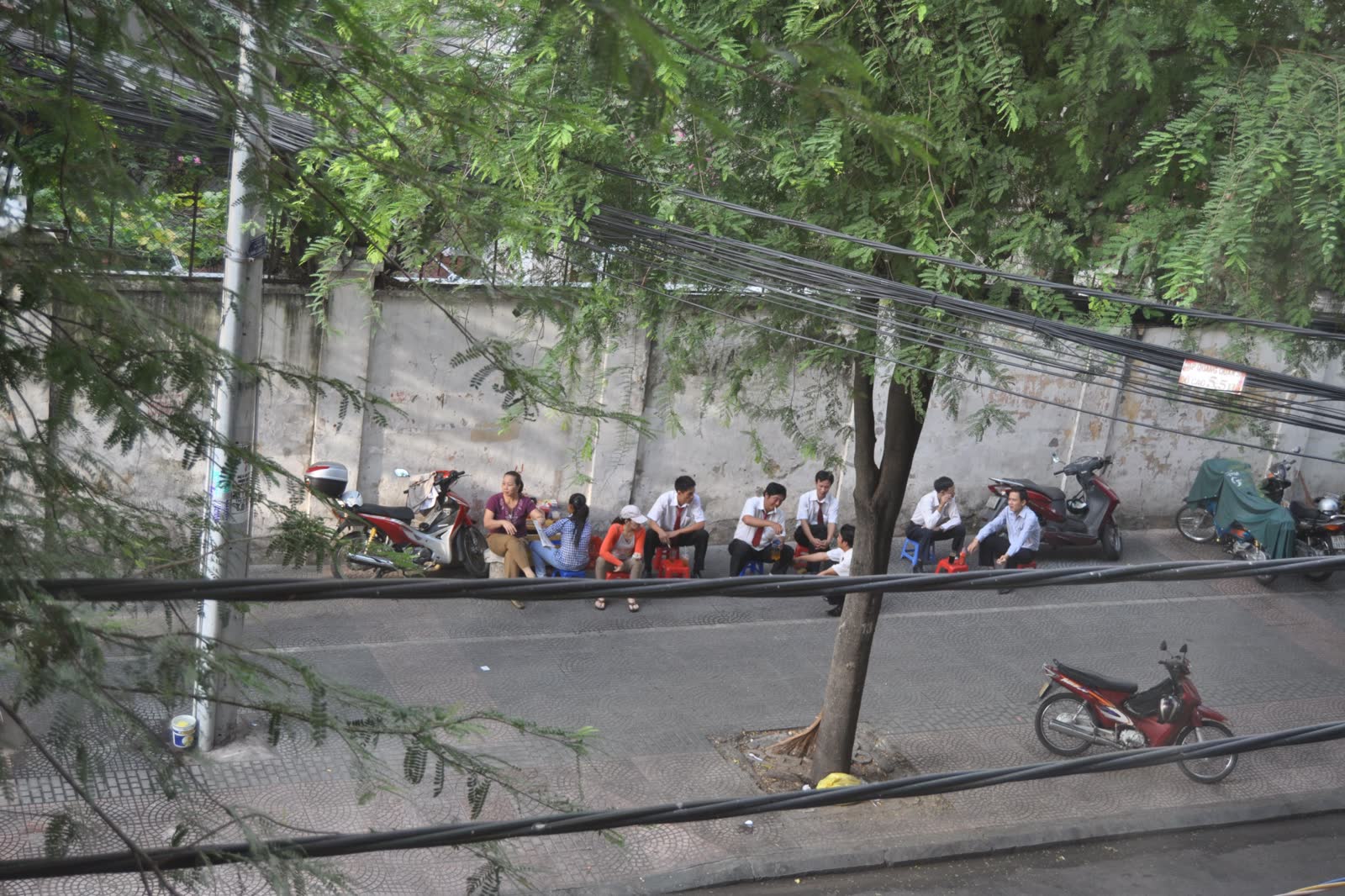 Daytime street on Thai Van Lung with Japanese noren curtains and wooden signs