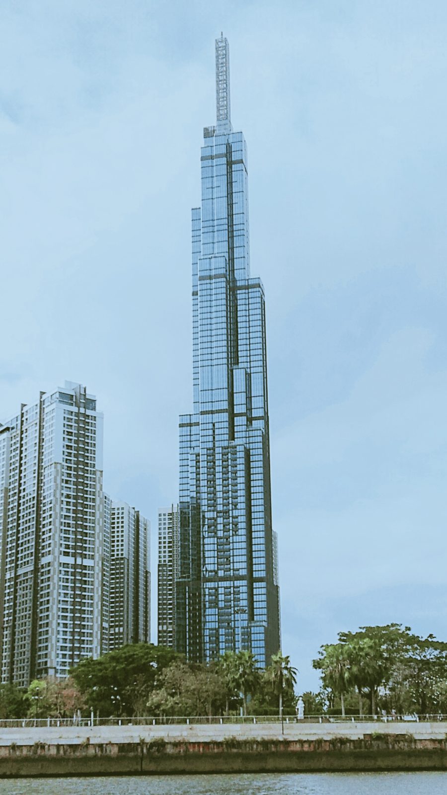 Landmark 81 from the riverbank, the full shaft and the lower blocks
