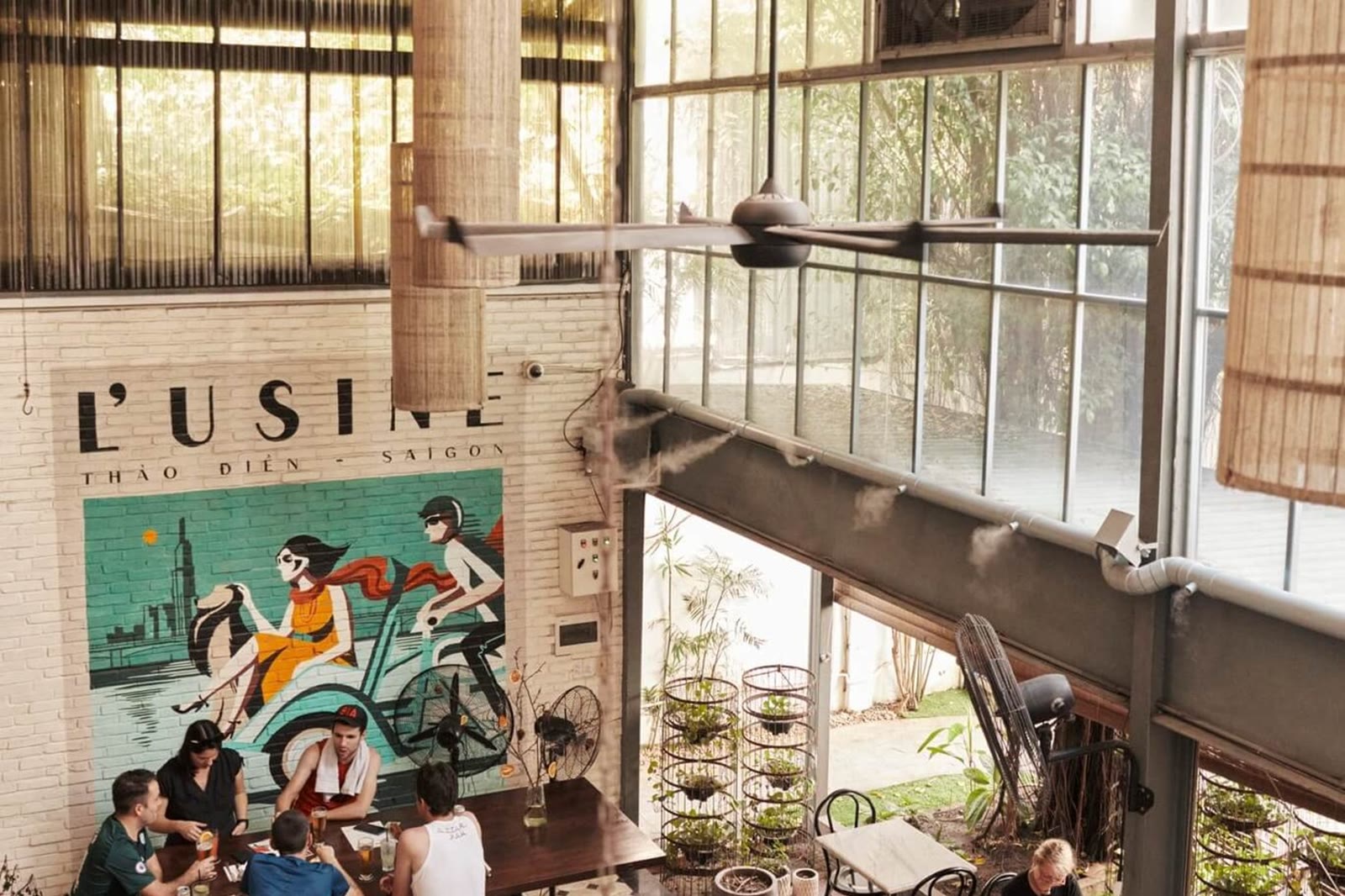 One brunch room in Thảo Điền, the Saigon mural under a high ceiling