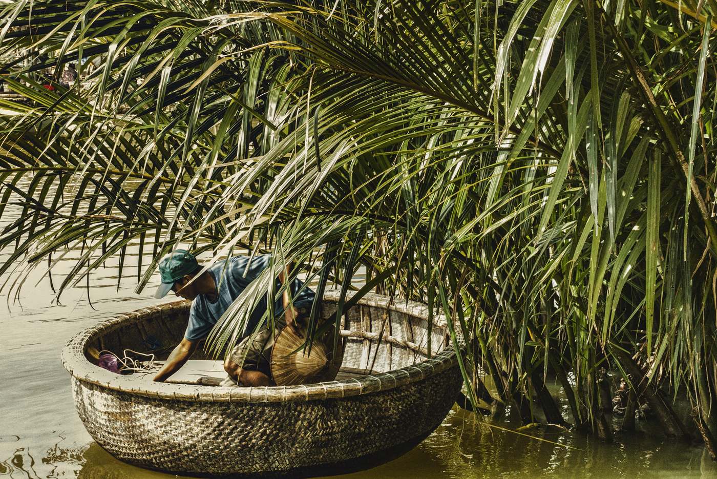 A basket boat under the nipa palms, with water in front