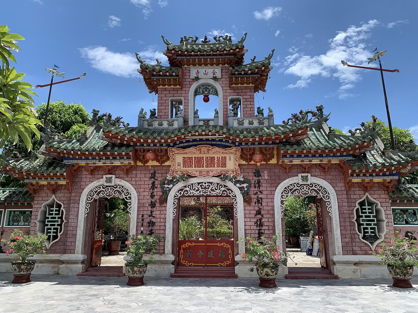 The tiled gate of the Fujian Assembly Hall in Hoi An, with three arched doors and a courtyard in front