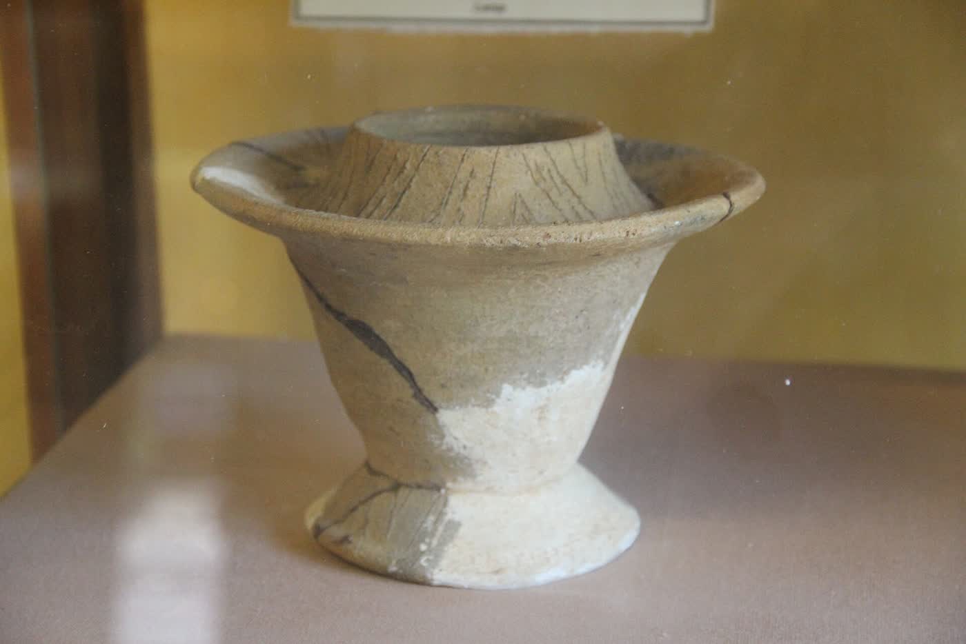 A footed ceramic jar with a wide rim, on display in the Sa Huynh Culture Museum