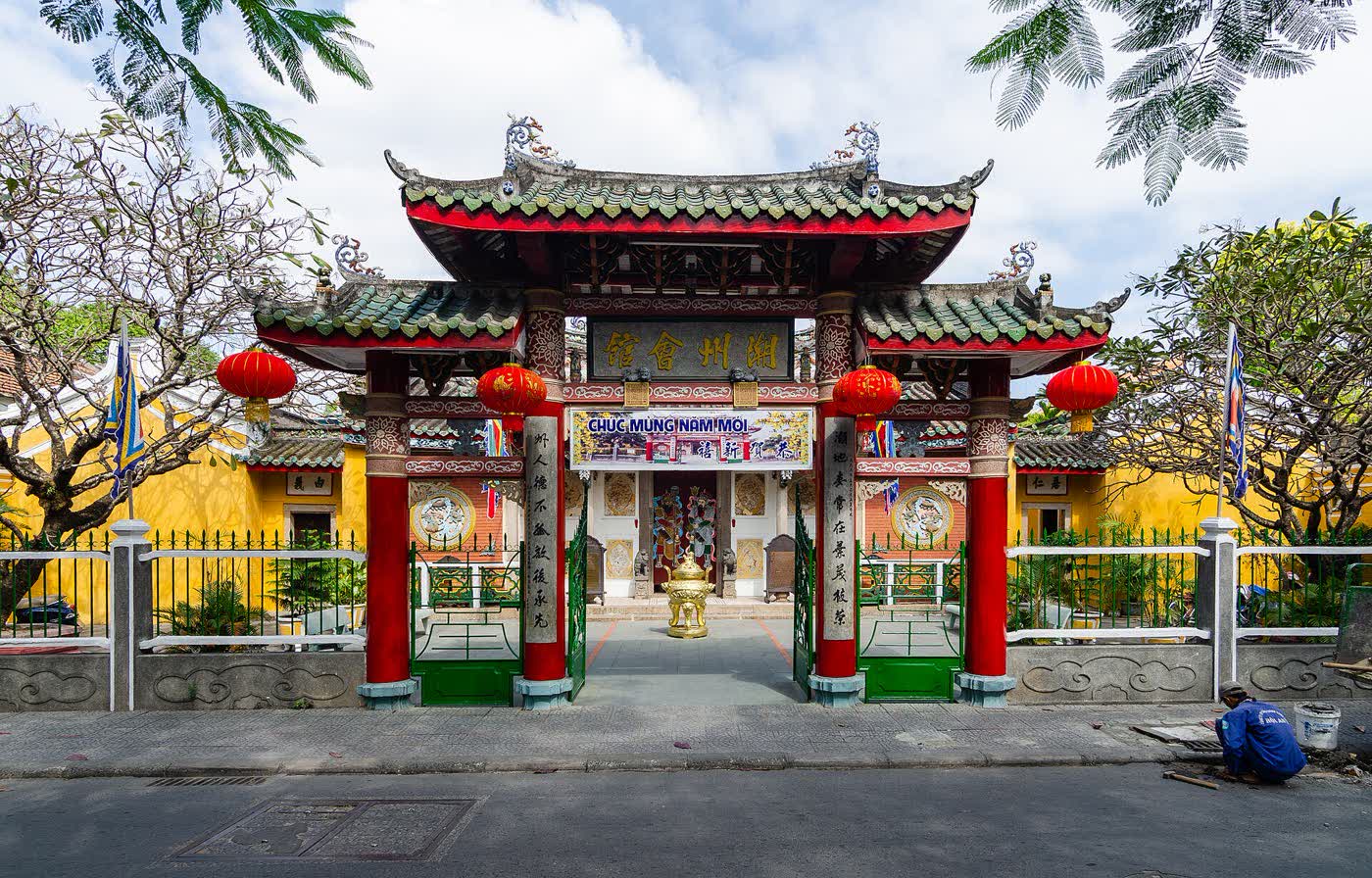 The red and green gate of the Chaozhou Assembly Hall in Hoi An, with lanterns