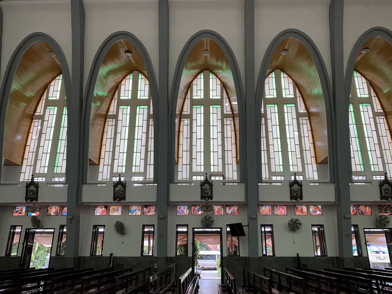 Tall windows along the wall of the nave at Phu Cam Cathedral