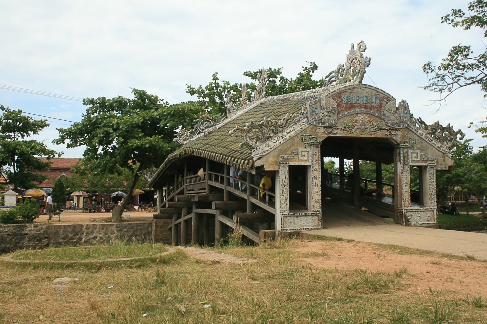 A carved portal under the tiled roof of Thanh Toan Bridge