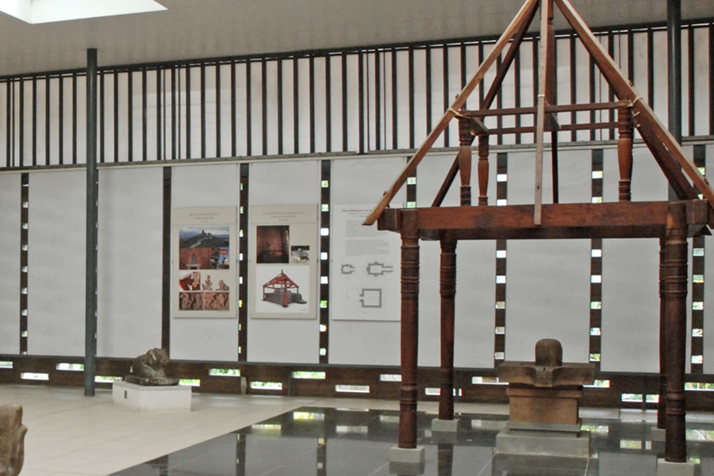 A wooden model of a Cham sanctuary roof over a stone linga in the My Son gallery