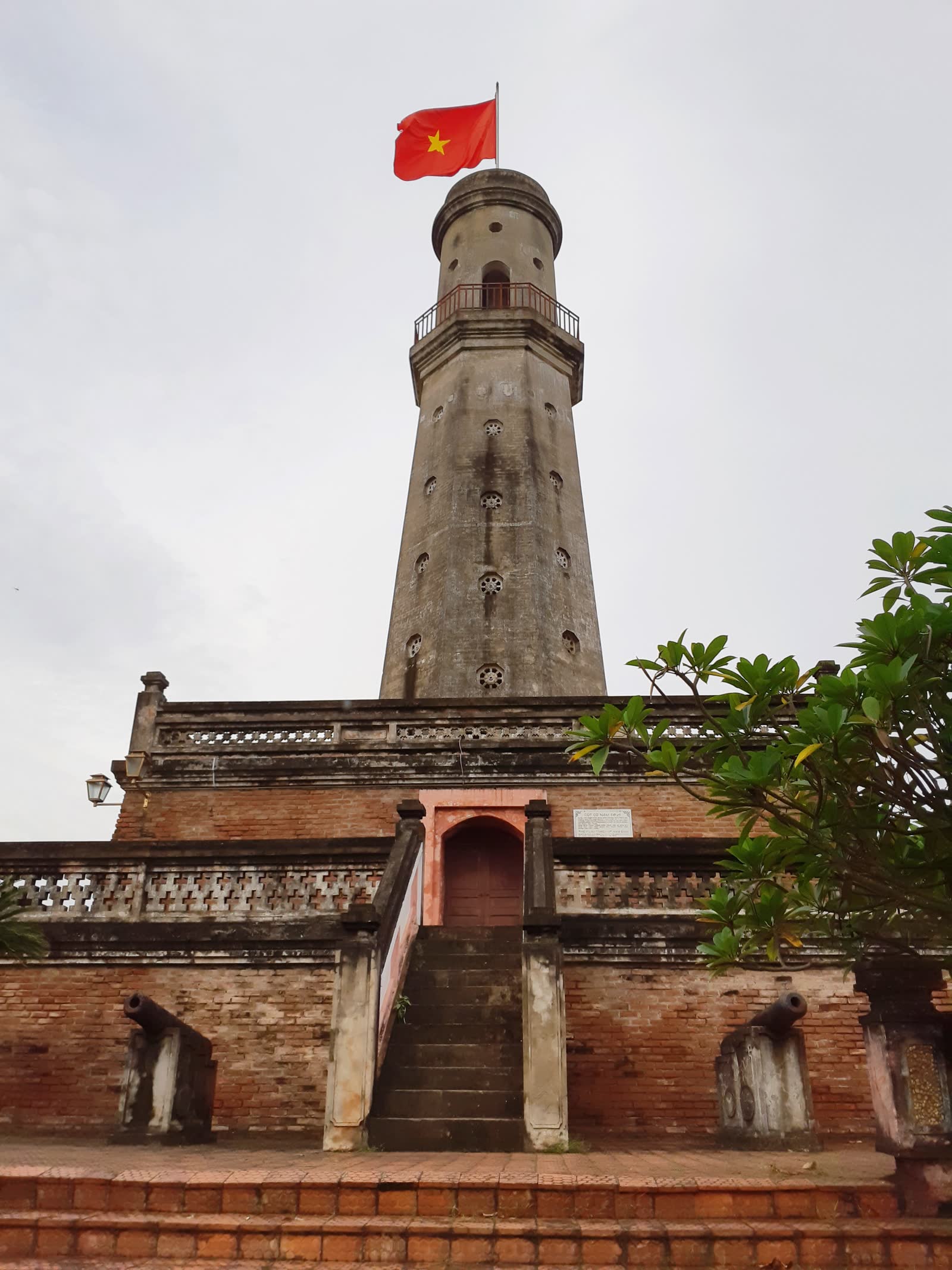 The Nam Dinh flag tower from the front steps, with the door in the brick base