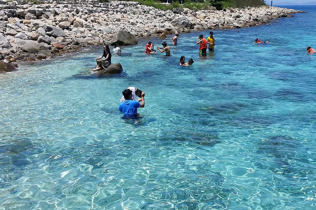 Swimmers in the water at Hòn Mun