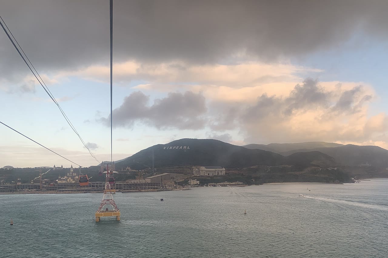 A cabin on the cable, with Hòn Tre and the Vinpearl hillside across the water