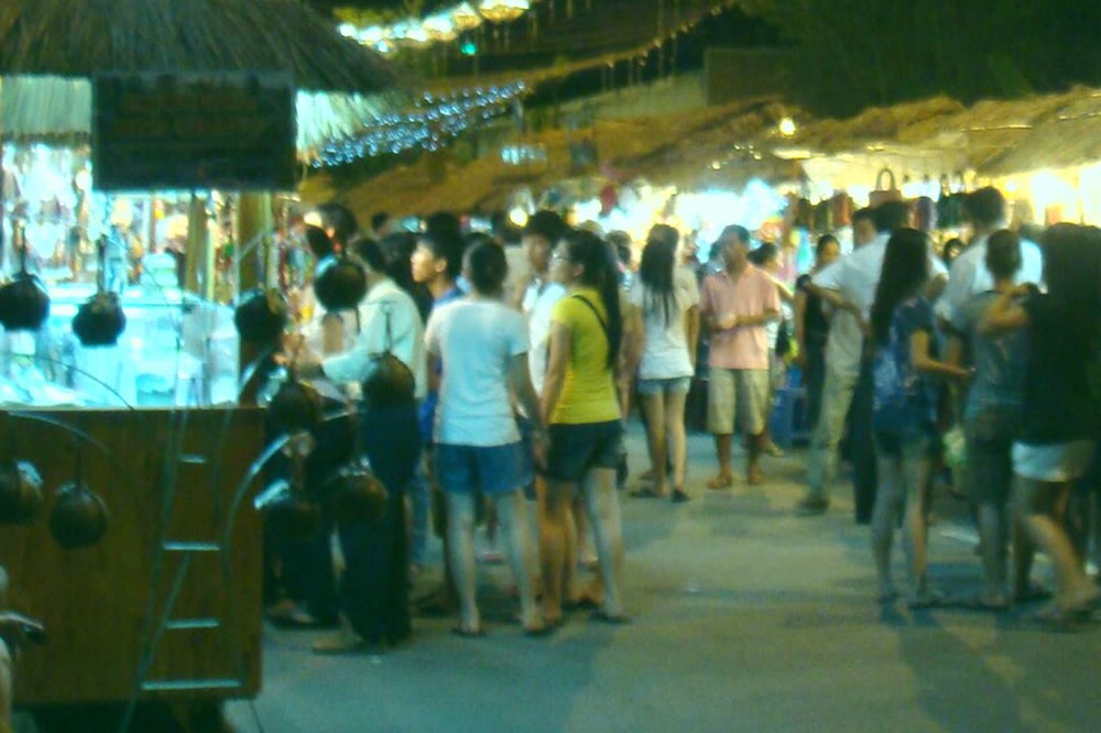 A closer view of night-market stalls and people