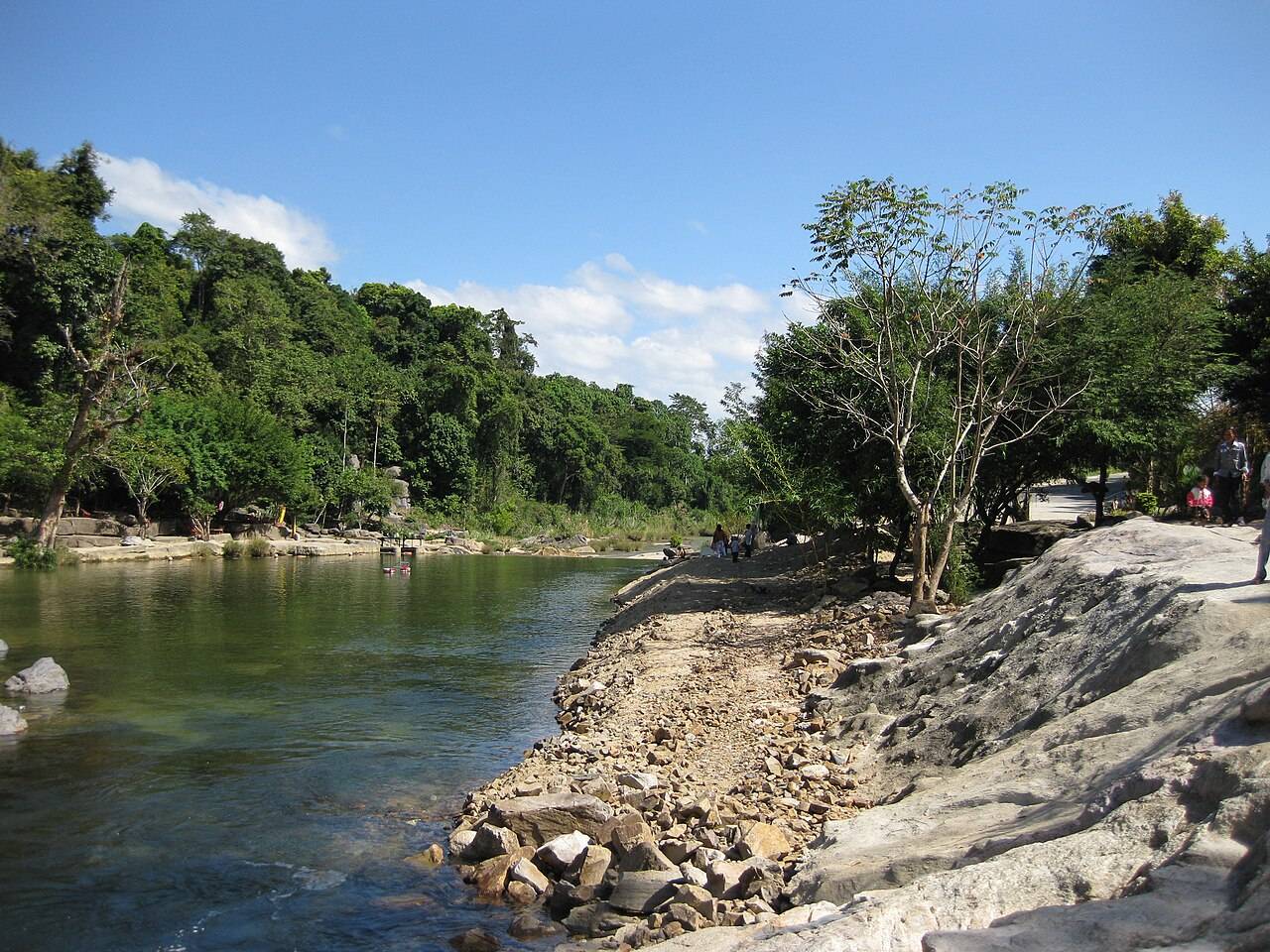 A rocky path along the green water at Yang Bay