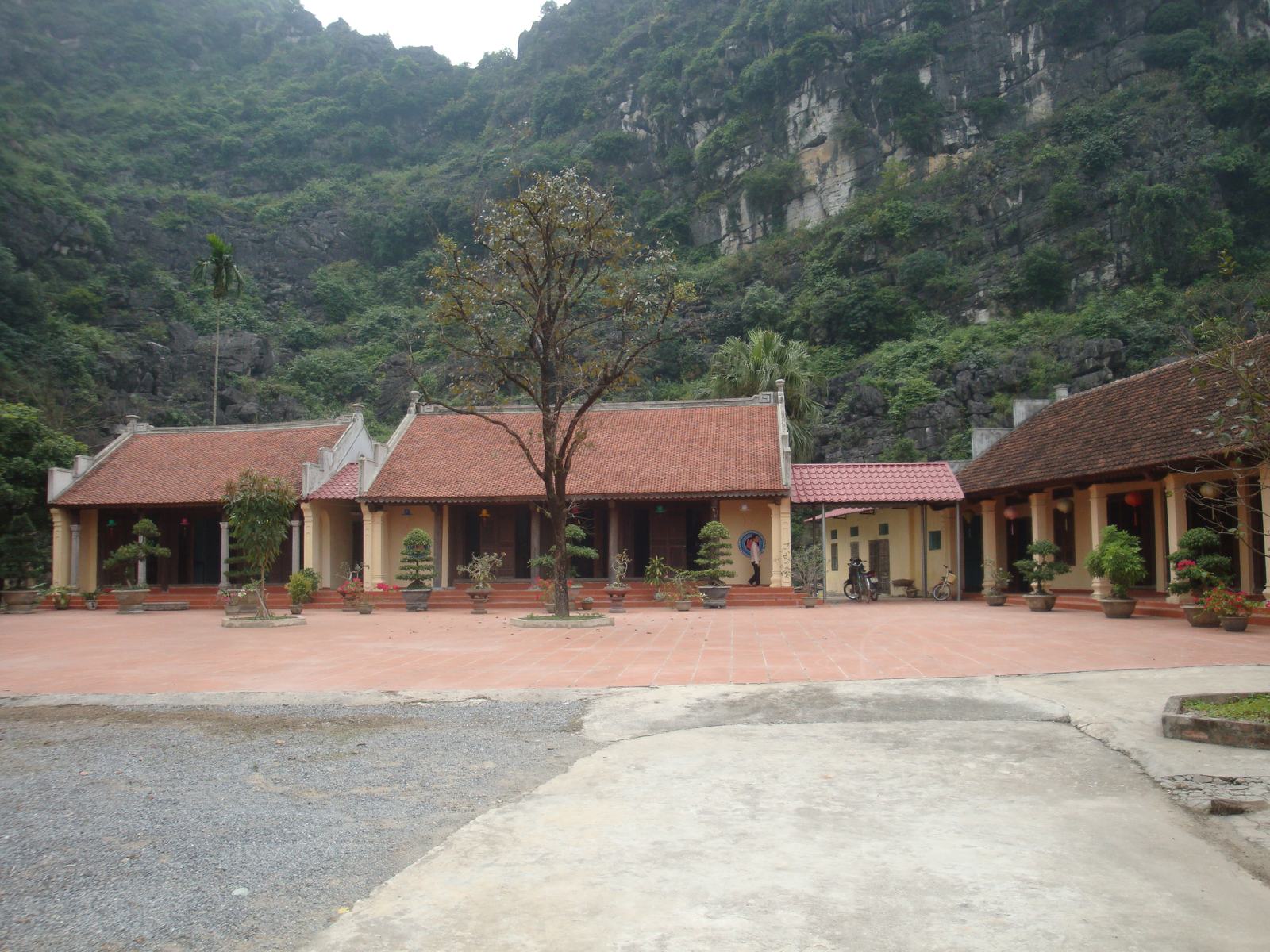 The tiled court of Duyen Ninh under the cliff