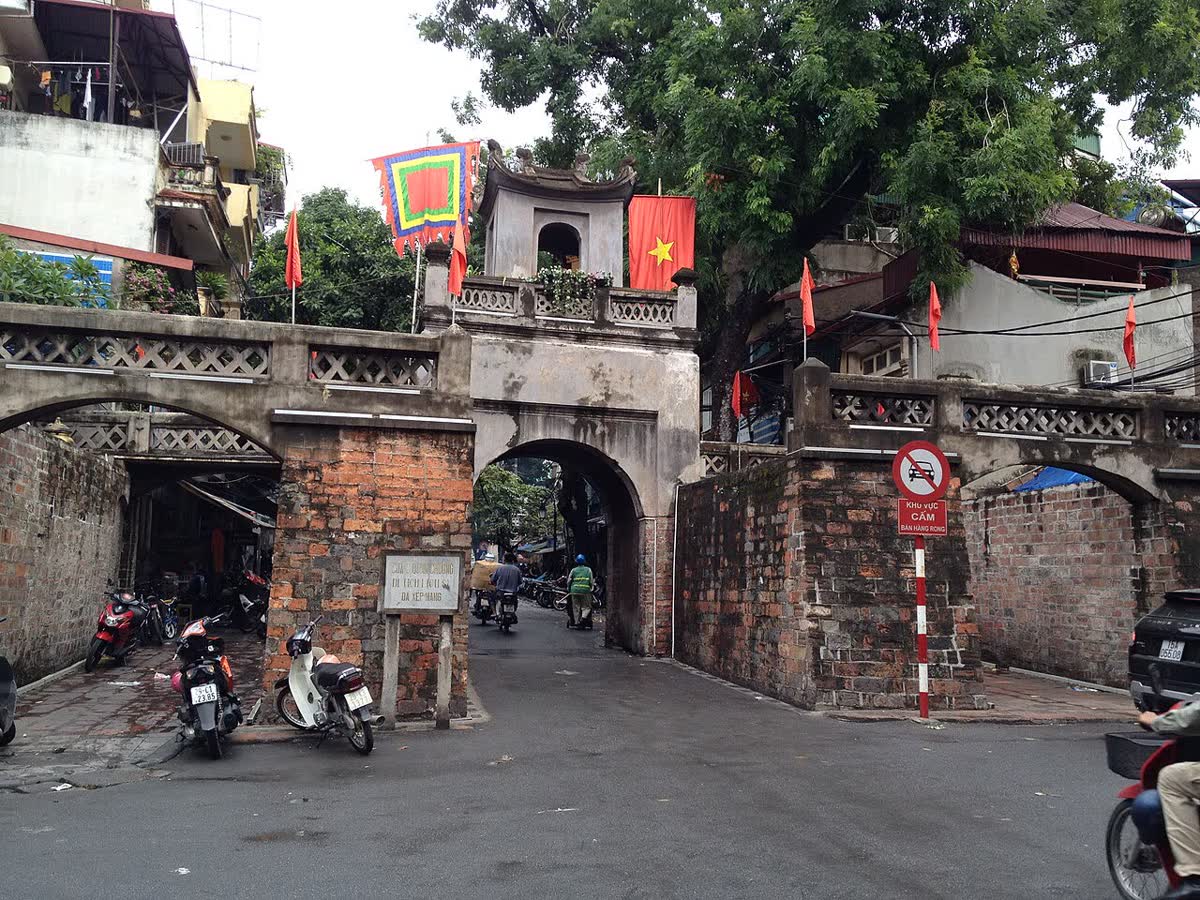 The west face of O Quan Chuong gate, brick walls and a watchtower over the arch