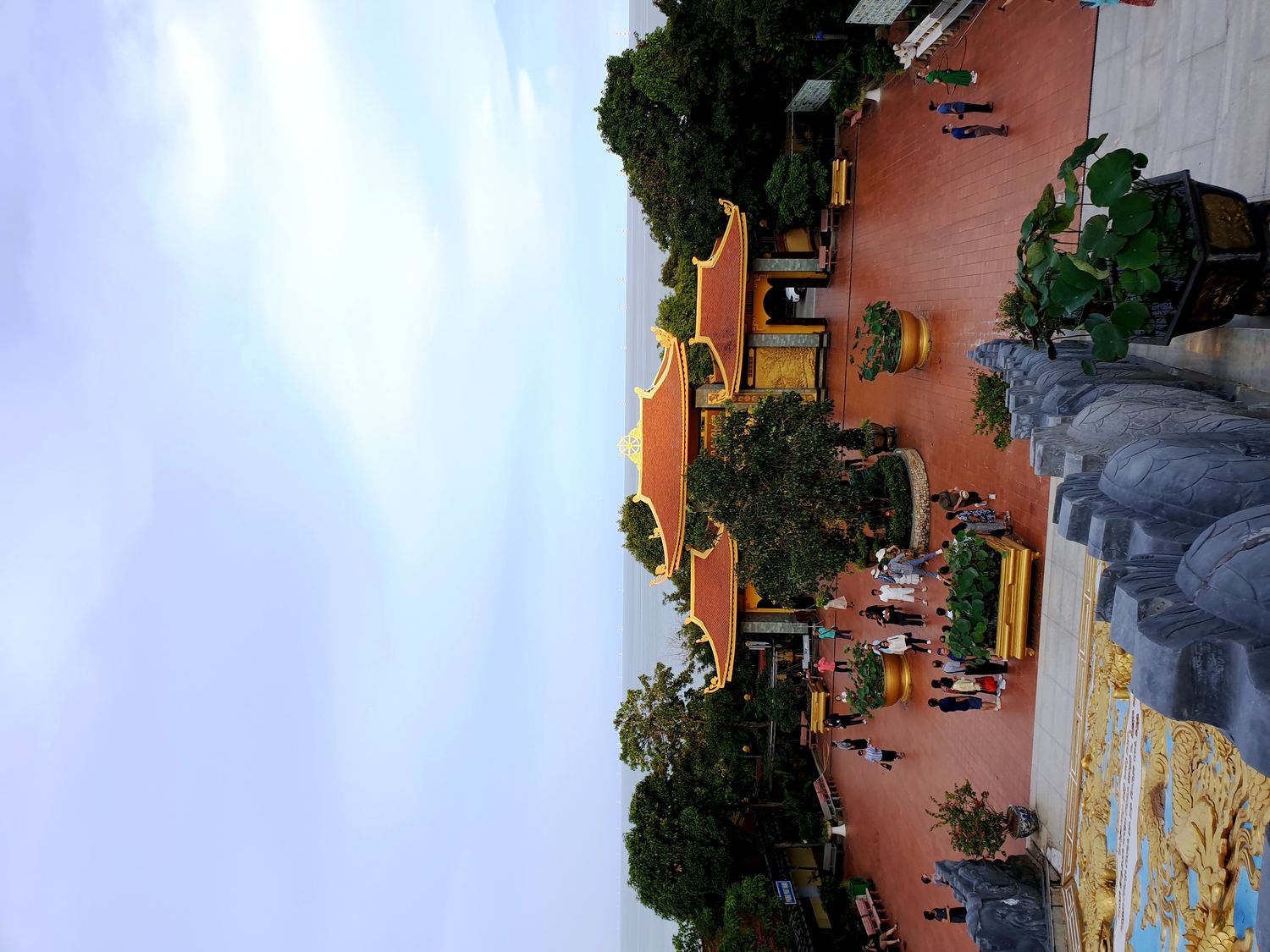 Courtyard and tiled roofs of Ho Quoc Pagoda with the sea behind