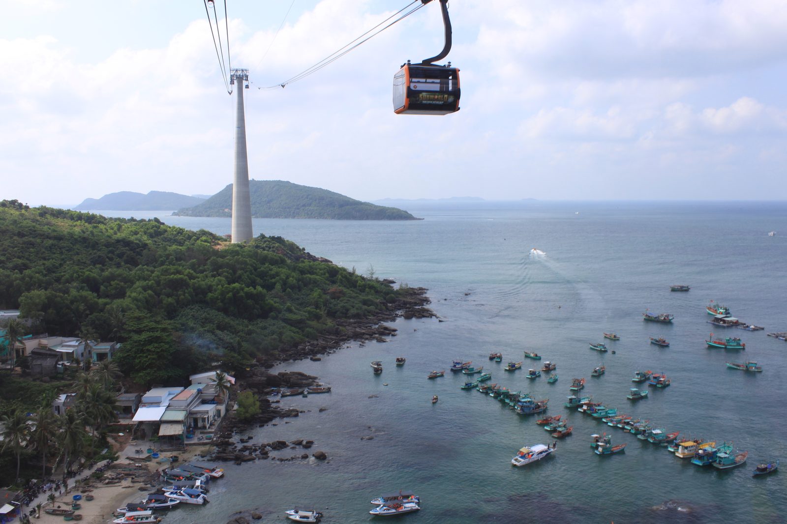 Hon Thom cable car cabin and pylon above fishing boats at An Thoi