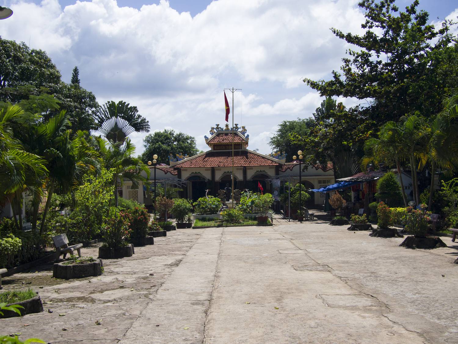 The shrine hall at the end of the courtyard, under a tiled roof and a flag