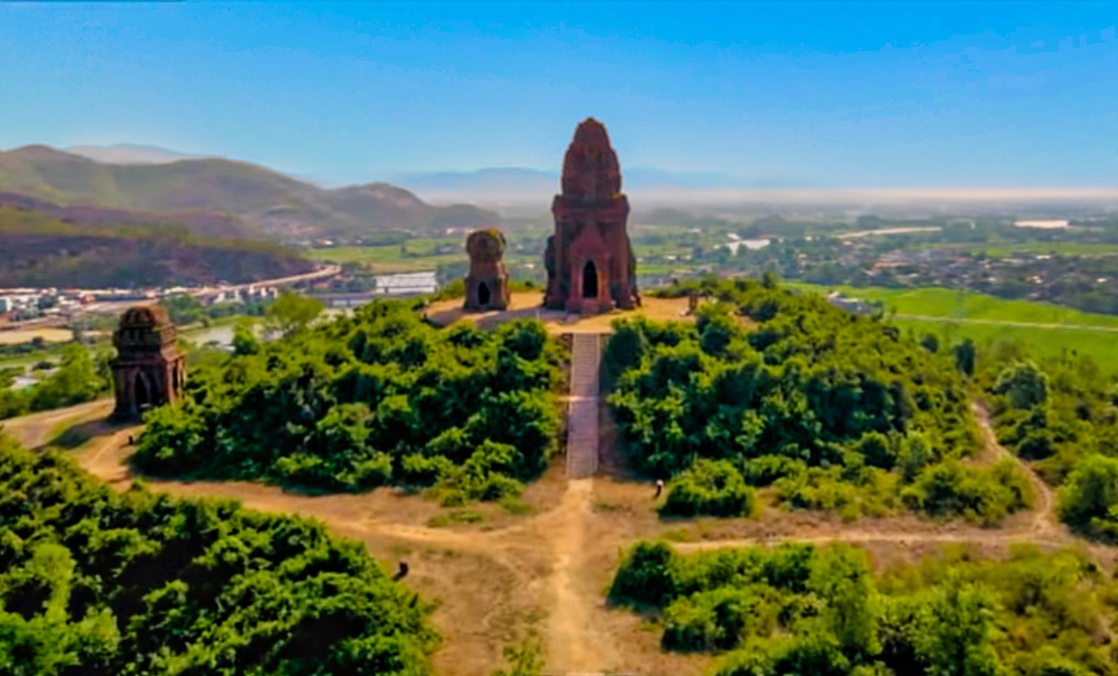 The towers on the hill, with the valley and the road behind