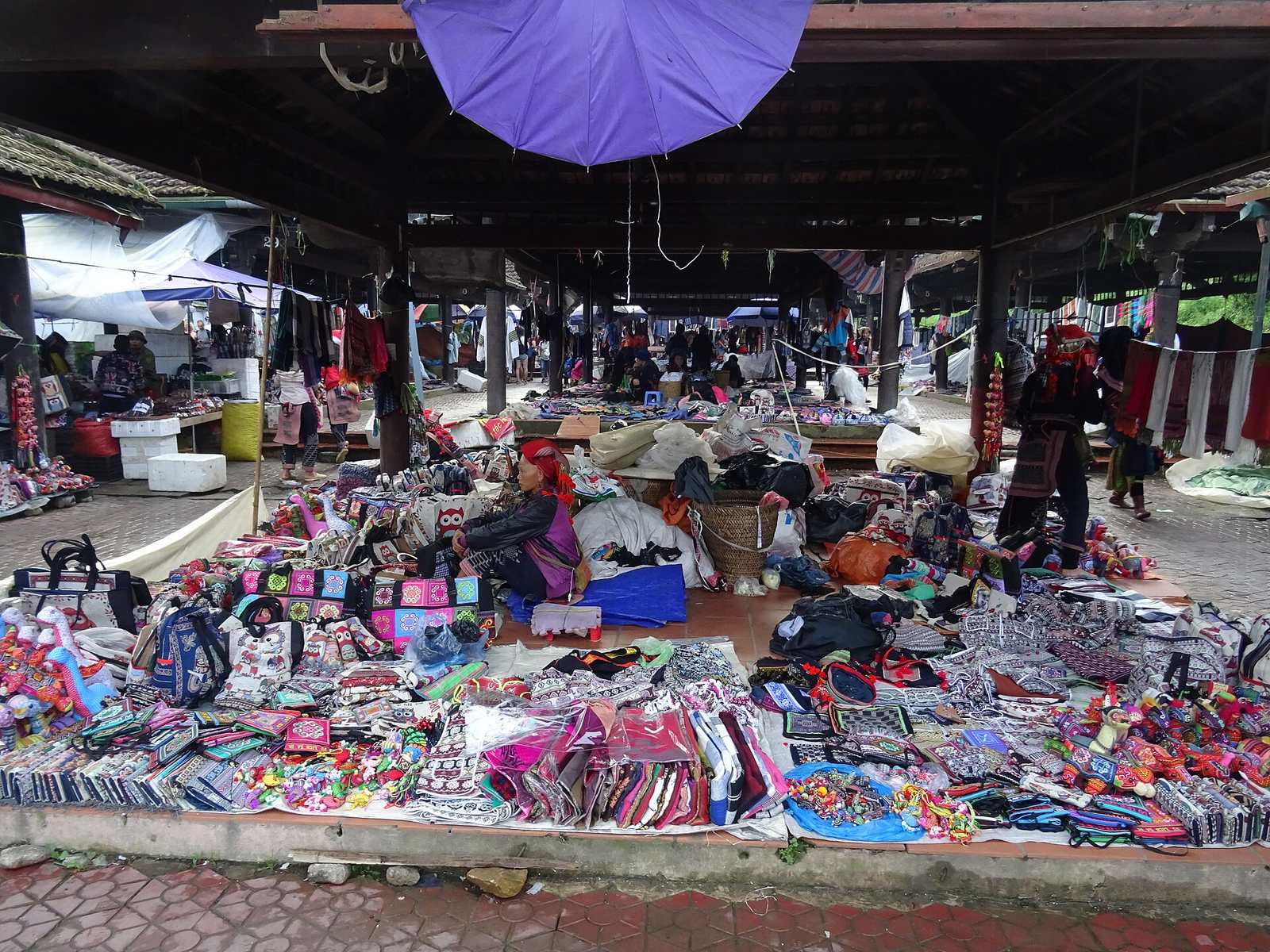 Piles of embroidered textiles in the covered Sa Pa market