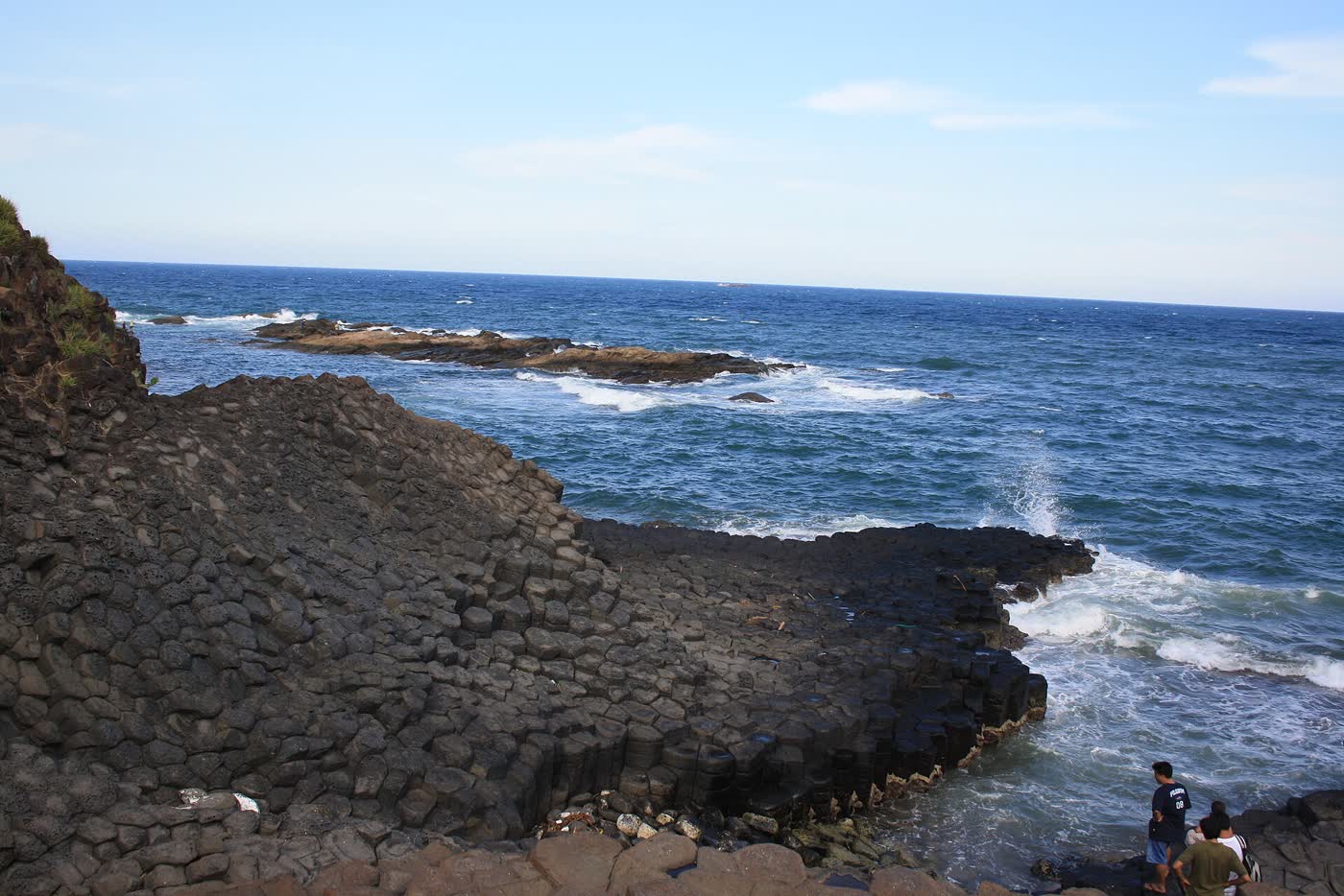 The black columns running into the sea