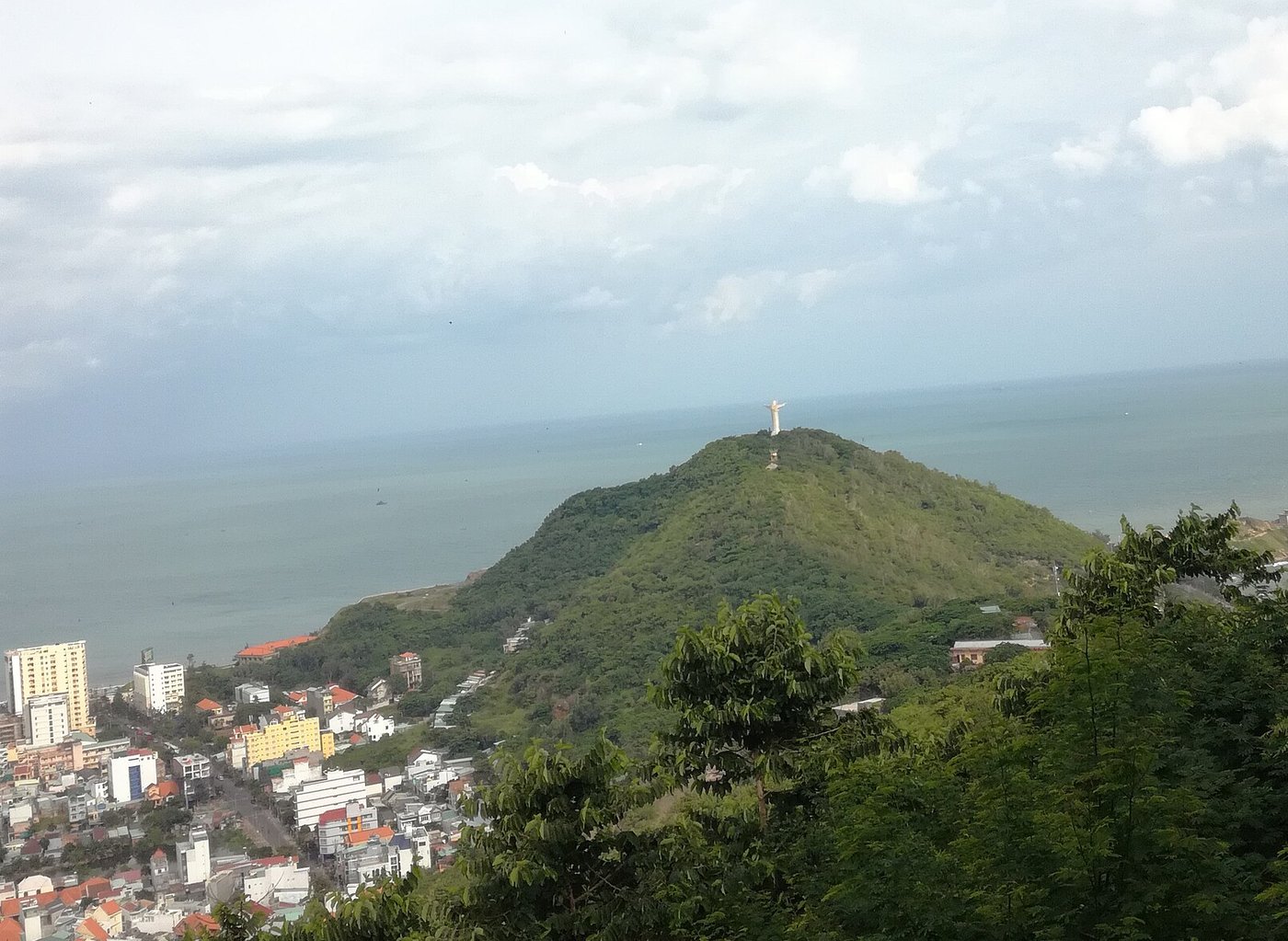 View from Vung Tau lighthouse over the city to the Christ statue on its headland and the sea